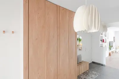 a living room with a large wooden cabinet at Royal Design Residence in Brussels
