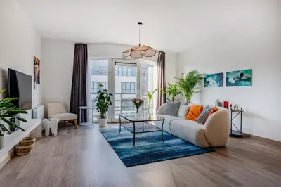 a living room with a couch and a glass table at Royal Design Residence in Brussels