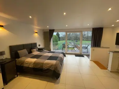 a bedroom with a bed and a view of a patio at B&B groot-bijgaarden center in Groot-Bijgaarden