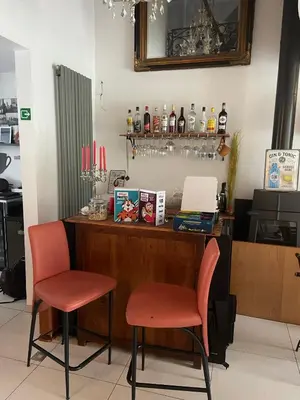 a bar with two chairs and a counter with drinks at B&B groot-bijgaarden center in Groot-Bijgaarden