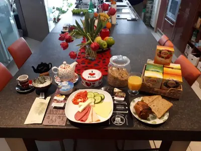 a table with plates of food on top of it at B&B groot-bijgaarden center in Groot-Bijgaarden