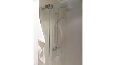 a shower in a bathroom next to a window at Albert Studio's in Mechelen