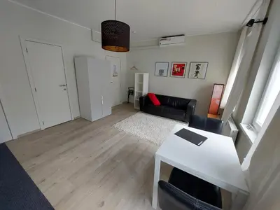 a living room with a couch and a table at Albert Studio's in Mechelen
