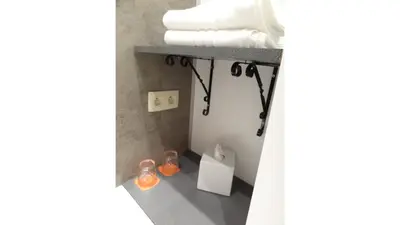 a bathroom with a shelf with towels on it at Albert Studio's in Mechelen