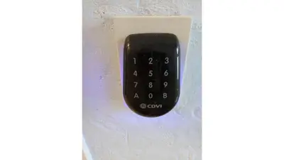 a black remote control hanging on a wall at Albert Studio's in Mechelen