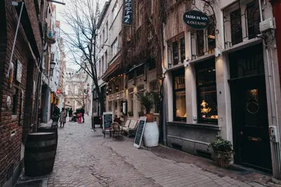 a cobblestone street in a city with buildings at De Moriaan Antwerp Historic Center in Antwerp