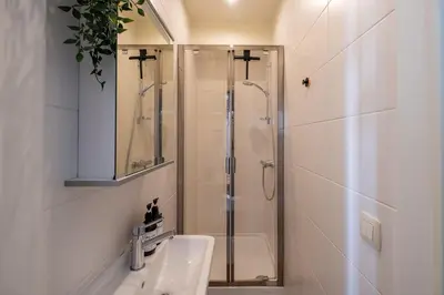 a bathroom with a shower and a sink at De Moriaan Antwerp Historic Center in Antwerp