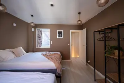 a bedroom with two beds and a window at De Moriaan Antwerp Historic Center in Antwerp