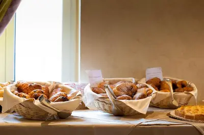 four baskets of pastries sitting on a table at Hotel Aviation in Brussels