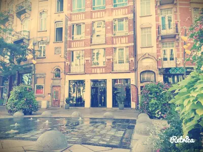 a building with a fountain in front of it at Hotel Aviation in Brussels