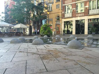 a fountain in the middle of a street with buildings at Hotel Aviation in Brussels