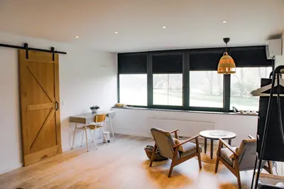a room with a table and chairs and a window at D&A nest in Retie