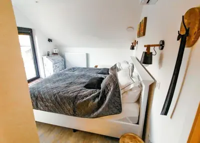 a bedroom with a bed in a white room at D&A nest in Retie
