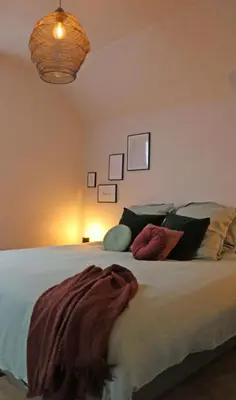 a bedroom with a bed with a blanket on it at Maison des Étoiles in Aalst