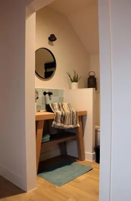 a bathroom with a vanity with a mirror and a sink at Maison des Étoiles in Aalst