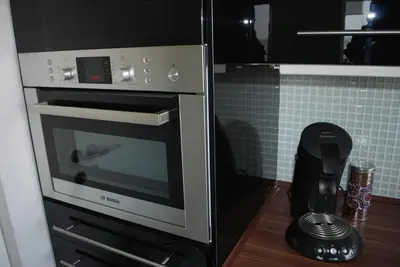 a kitchen with an oven and a blender on a counter at Apartment View of Antwerp in Antwerp