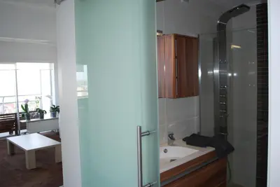 a bathroom with a shower and a bath tub at Apartment View of Antwerp in Antwerp
