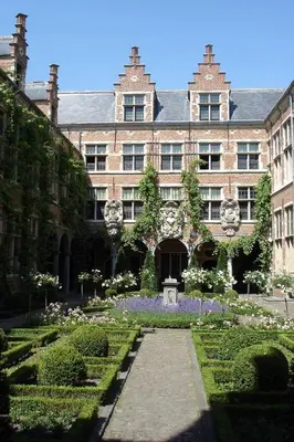 an old building with a garden in front of it at Apartment View of Antwerp in Antwerp