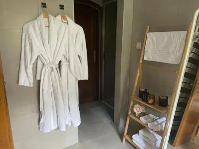 a robe hanging on a rack in a bathroom at B&B Monroe in Averbode
