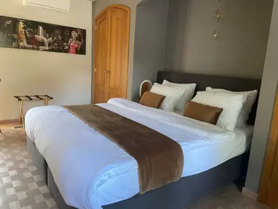 a bedroom with a large bed with white sheets at B&B Monroe in Averbode