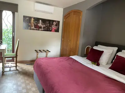 a bedroom with a large bed with a red blanket at B&B Monroe in Averbode