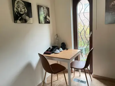 a table and chairs in a room with a window at B&B Monroe in Averbode