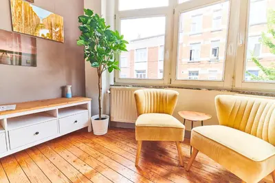 a living room with two chairs and a table at César in Brussels