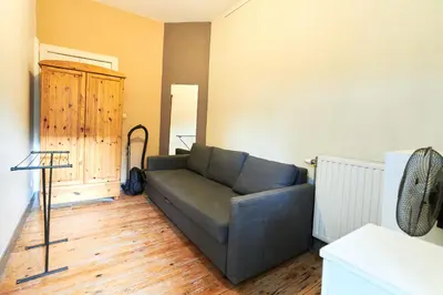 a living room with a couch and a wooden floor at César in Brussels