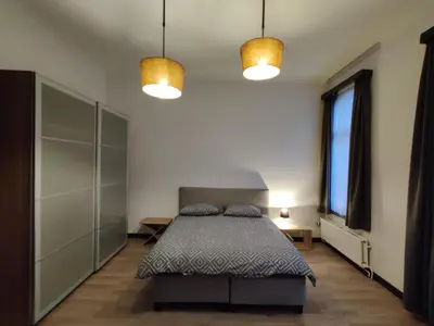 a bedroom with a bed with two pillows on it at Modern duplex 100m2 perfect to visit Brussels in Brussels
