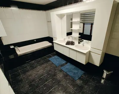 a bathroom with two sinks and a bath tub at Modern duplex 100m2 perfect to visit Brussels in Brussels