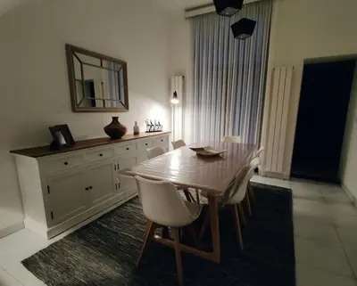 a dining room with a wooden table and chairs at Modern duplex 100m2 perfect to visit Brussels in Brussels