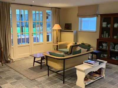 a living room with a couch and a table at Schilde Cottage in Schilde