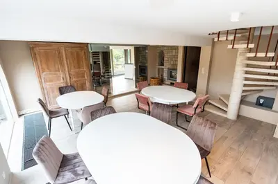 a room with two tables and chairs and a staircase at Raesborre Homes - Self Check-in in Leuven