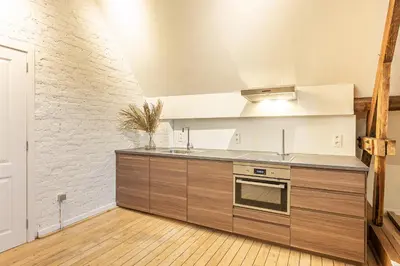 a kitchen with a sink and a stove top oven at Raesborre Homes - Self Check-in in Leuven