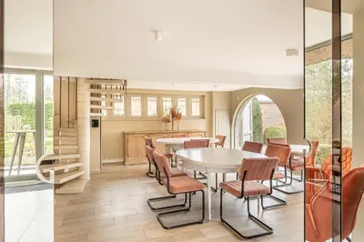 a kitchen and dining room with a table and chairs at Raesborre Homes - Self Check-in in Leuven