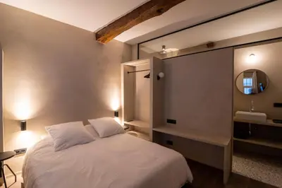 a bedroom with a white bed and a mirror at Charming House in Le Sablon in Brussels