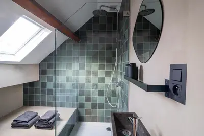 a bathroom with a shower and a sink at Charming House in Le Sablon in Brussels