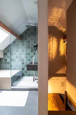 a bathroom with a sink and a glass shower at Charming House in Le Sablon in Brussels