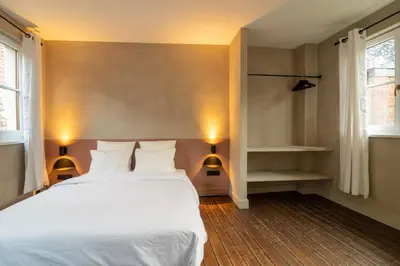 a bedroom with a white bed and two lamps at Lovely triplex in the heart of Le Sablon in Brussels