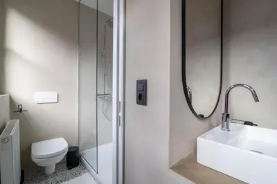 a bathroom with a sink and a toilet and a shower at Lovely triplex in the heart of Le Sablon in Brussels