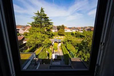 a view of a garden from a window at Su'ro Bed and Breakfast in Ghent