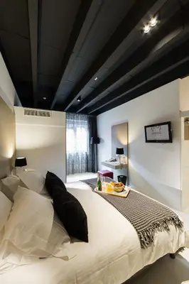 a bedroom with a large bed with a black ceiling at City Garden Ghent in Ghent