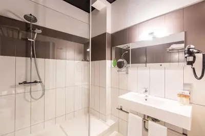 a bathroom with a shower and a sink at City Garden Ghent in Ghent