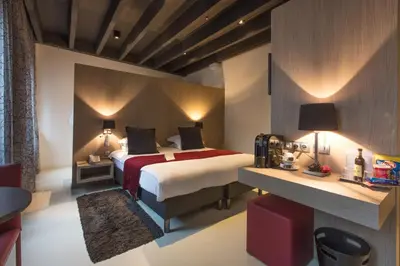 a hotel room with a bed and a desk at City Garden Ghent in Ghent