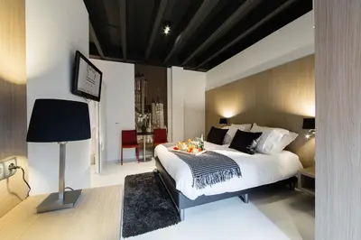 a bedroom with a large bed with a table on it at City Garden Ghent in Ghent
