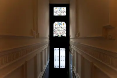 a hallway with a stained glass window in a building at Apartment in trendy Chatelain center Brussels area Little Garden Internet wifi in Brussels