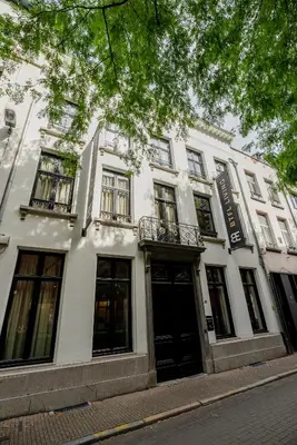a white building with black doors and windows at BTFL Living, Luxury Residences Antwerp, Zirkstraat in Antwerp