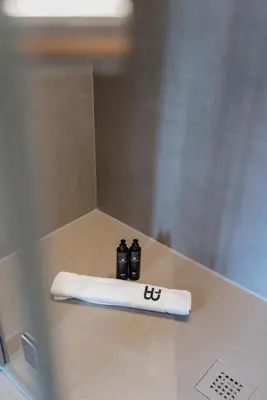 a white towel sitting on a counter in a shower at BTFL Living, Luxury Residences Antwerp, Zirkstraat in Antwerp