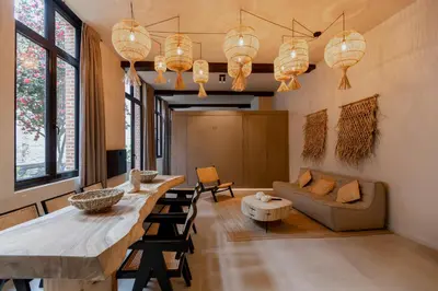 a living room with a long table and a couch at BTFL Living, Luxury Residences Antwerp, Zirkstraat in Antwerp