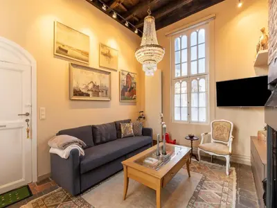 a living room with a couch and a table at Apartment in Kruibeke Wissekerke Castle in Kruibeke